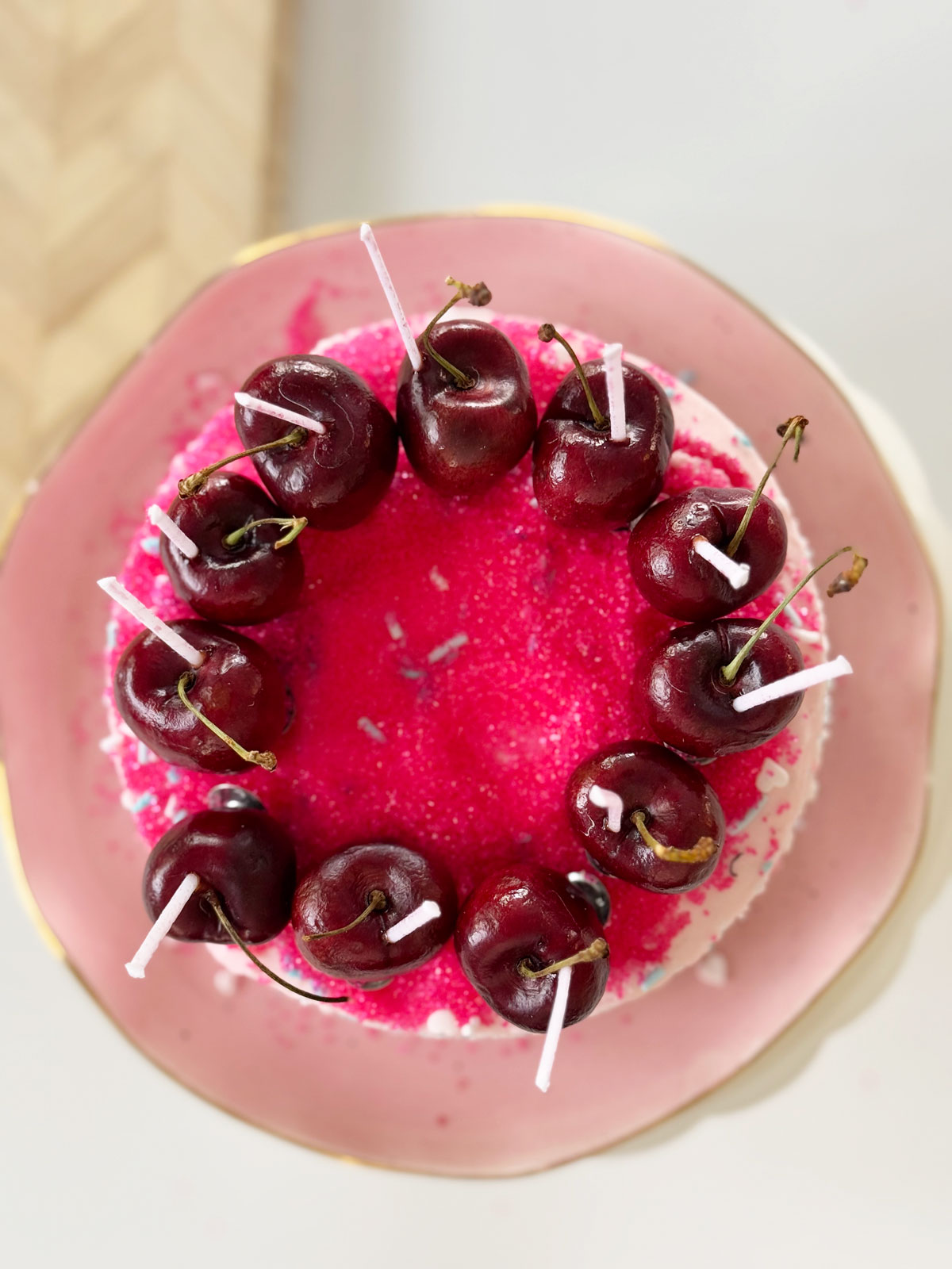 Cherry birthday cake topper of homemade cherry candles.