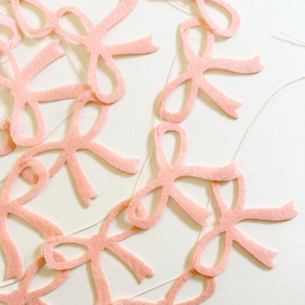 Light peach pink bow garland.