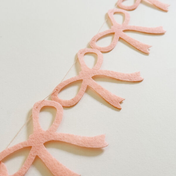 Pink bow baby shower garland for girl.