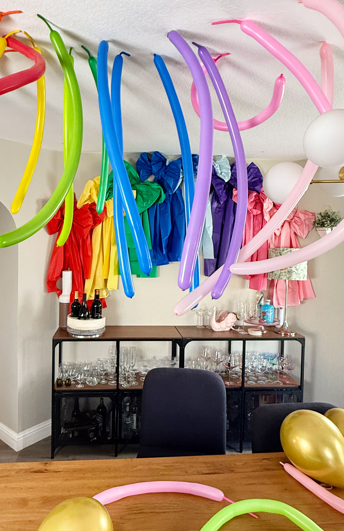 Rainbow balloon party ideas, helium balloon hack for hanging.