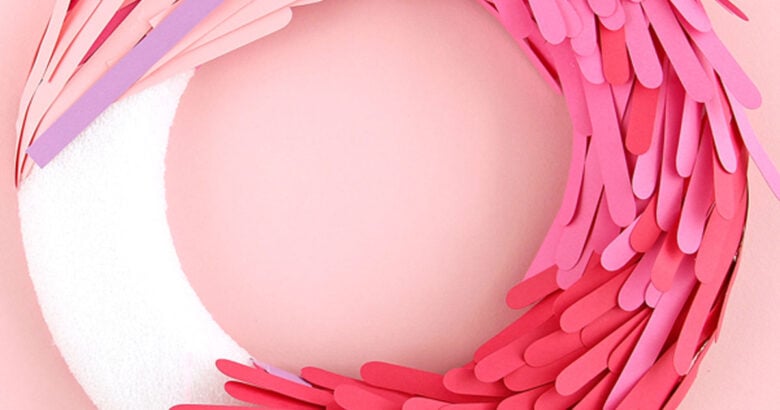 Popsicle stick wreath Christmas DIY project with instructions.