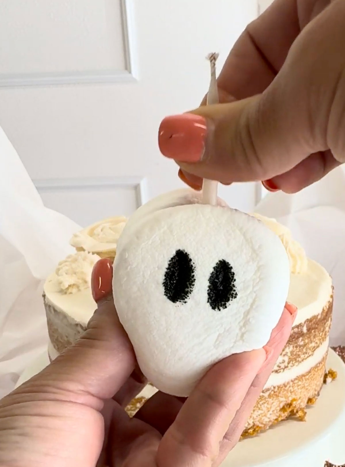 Marshmallow ghost candles for ghost birthday cake.